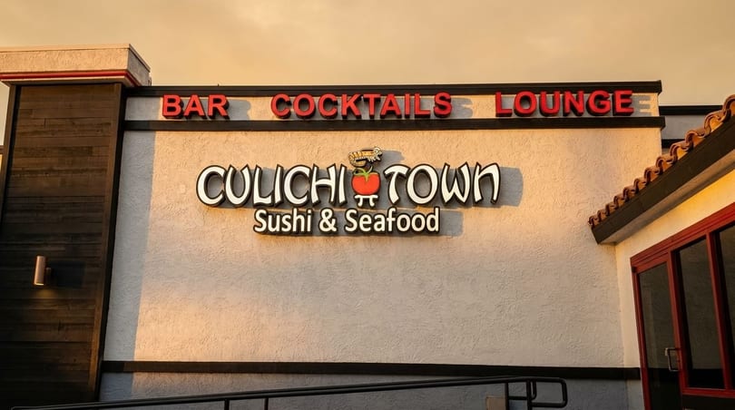 Exterior sign for "CuliChi Town Sushi & Seafood Bar Cocktails Lounge" with a tomato and shrimp logo.